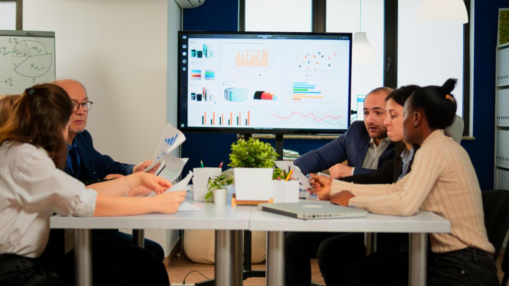 Ambitious professionals engaging in structured mentorship and strategic wealth building