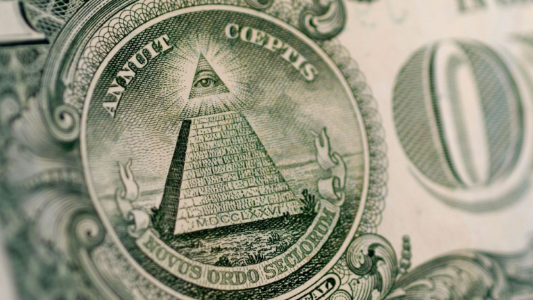 The all seeing eye symbol displayed inside a glowing triangle atop a stone pyramid